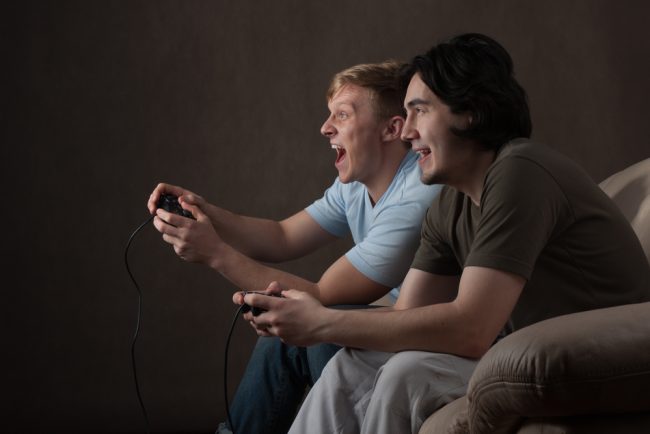 Two,Friends,Are,Focused,On,Playing,Video,Games,On,Gray